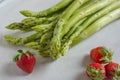 Healthy organic green fresh asparagus with a bunch of healthy strawberries Royalty Free Stock Photo