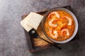 Healthy organic pumpkin cream soup with shrimps, sesame seeds and thyme close-up on a wooden tray. Horizontal top view Royalty Free Stock Photo