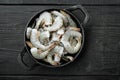 Healthy organic tiger shrimps, in cast iron frying pan, on black wooden background, top view flat lay Royalty Free Stock Photo