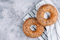 Healthy organic whole grain bagel on concrete table. Breakfast bread. Copy space, top view Royalty Free Stock Photo