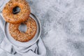 Healthy organic whole grain bagel on concrete table. Breakfast bread. Copy space, top view Royalty Free Stock Photo