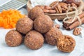 Healthy paleo energy balls with carrot, nuts, dates and coconut flakes, on parchment, horizontal Royalty Free Stock Photo