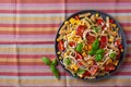 healthy pasta salad with zucchini sweet corn tomato and basil, vegetarian lunch Royalty Free Stock Photo