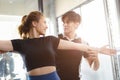 Healthy people asian young woman sport exercise in fitness gym sport club with personal trainer instructors help support Royalty Free Stock Photo