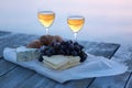 Healthy picnic for a summer vacation with freshly baked croissants, fresh fruit, vegetables, cheese laid out on a blue and white Royalty Free Stock Photo