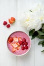 Healthy Pink Smoothie in the Bowl from Banana and Strawberries w