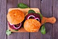 Healthy plant based beet burgers, top view on a wooden board Royalty Free Stock Photo
