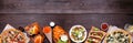 Healthy plant based fast food bottom border. Top view over a dark wood banner background. Copy space. Royalty Free Stock Photo