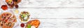 Healthy plant based fast food corner border. Top view over a white wood banner background. Copy space. Royalty Free Stock Photo