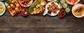 Healthy plant based summer bbq top border over a dark wood banner background Royalty Free Stock Photo