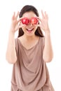 Healthy and playful woman covering her eyes with two red apples Royalty Free Stock Photo