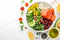 Healthy poke bowl salad meal of Salmon, avocado, cucumber, tomato, beans and rice on white background Royalty Free Stock Photo