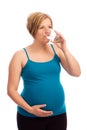 Healthy pregnant Caucasian woman drinking water