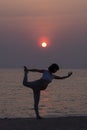 Healthy pregnant woman doing yoga on the beach Royalty Free Stock Photo