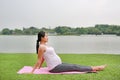 Healthy pregnant woman doing yoga in nature outdoors Royalty Free Stock Photo