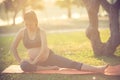 Healthy pregnant woman doing yoga in nature outdoors. Royalty Free Stock Photo