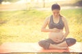 Healthy pregnant woman doing yoga in nature outdoors. Royalty Free Stock Photo