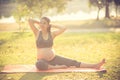 Healthy pregnant woman doing yoga in nature outdoors. Royalty Free Stock Photo