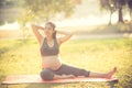 Healthy pregnant woman doing yoga in nature outdoors. Royalty Free Stock Photo