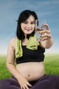 Healthy pregnant woman offers water Royalty Free Stock Photo