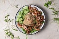 Healthy quinoa with grilled prawns or shrimps, cucumber and micro greens on the marble background. Royalty Free Stock Photo