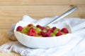 Healthy raw food diet breakfast. Flaxseed porridge with grapes and raspberries in white bowl.