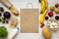 Healthy raw food with paper bag on white wooden table. Cooking food background. Flat lay of fresh fruits, veggies, greens, meat, m Royalty Free Stock Photo