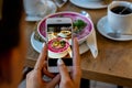 Smartphone food photography carrot soup in bowl. Woman hands take phone photo of dinner or lunch for social networks. Royalty Free Stock Photo