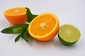 Healthy ripe delicious fruits for human health. Juicy fruits of orange orange with bright green mint. Two halves of an orange with Royalty Free Stock Photo