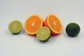 Healthy ripe delicious fruits for human health. Juicy fruits of orange orange, lime with bright green mint. Two halves of an orang Royalty Free Stock Photo