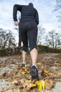 A healthy runner running in autumn leaves