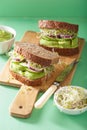 Healthy rye sandwich with avocado cucumber alfalfa sprouts Royalty Free Stock Photo