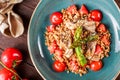 Healthy salad of barley porridge with asparagus, tomatoes and mushrooms on plate. Vegan food. Royalty Free Stock Photo