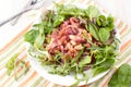 Healthy salad with beans, prosciutto and greens