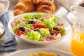 Healthy salad in a bowl with olives, raddishes, tomato, cheese and lean ham served for breakfast Royalty Free Stock Photo