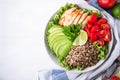 Healthy salad bowl with quinoa, tomatoes, chicken, avocado, lime and mixed greens, lettuce, parsley Royalty Free Stock Photo