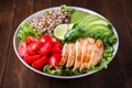 Healthy salad bowl with quinoa, tomatoes, chicken, avocado, lime and mixed greens, lettuce, parsley Royalty Free Stock Photo