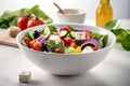 Healthy salad bowl with tomatoes, cucumbers, fresh vegetables, feta cheese and mixed greens on table. Food and health Royalty Free Stock Photo