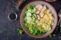 Healthy salad with chicken, avocado, cucumber, lettuce, radish and pasta on dark background. Proper nutrition. Dietary menu. Dinn