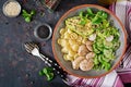 Healthy salad with chicken, avocado, cucumber, lettuce, radish and pasta on dark background. Proper nutrition. Dietary menu. Dinn