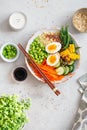 Healthy salad with couscous, carrots, cucumber, green beans, soybeans, corn and an egg on a gray concrete background. Food and Royalty Free Stock Photo