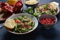 Healthy salad with couscous, fresh mint, cucumber, pomegranate, lemon and olive oil.