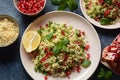 Healthy salad with couscous, fresh mint, cucumber, pomegranate, lemon and olive oil.