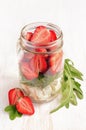 Healthy salad dish with fresh strawberry, arugula and soft cheese in glass jar Royalty Free Stock Photo