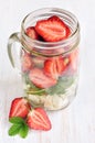 Healthy salad dish with fresh strawberry, arugula and soft cheese in glass jar Royalty Free Stock Photo