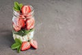 Healthy salad dish with fresh strawberry, arugula and soft cheese in glass jar Royalty Free Stock Photo