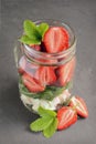 Healthy salad dish with fresh strawberry, arugula and soft cheese in glass jar Royalty Free Stock Photo