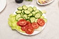 healthy salad with fresh ripe summer vegetables , tomato, cucumber , radishes , spices and white toast on a wooden background Royalty Free Stock Photo