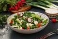 Healthy salad with fresh vegetables: radish, cucumbers, green onions, parsley, tomatoes, cabbage and spinach Royalty Free Stock Photo