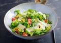 Healthy salad of fresh vegetables - tomatoes, avocado, corn salad, pea sprouts and chia seeds in bowl. Royalty Free Stock Photo